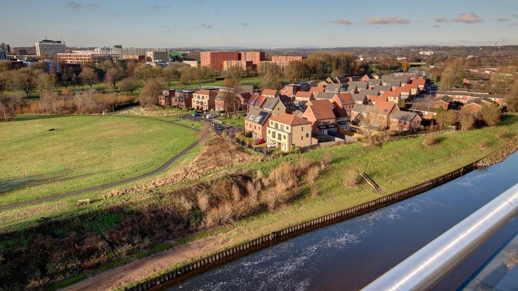 an aerial view of a town next to a river at Meadow Park Villas in Manchester