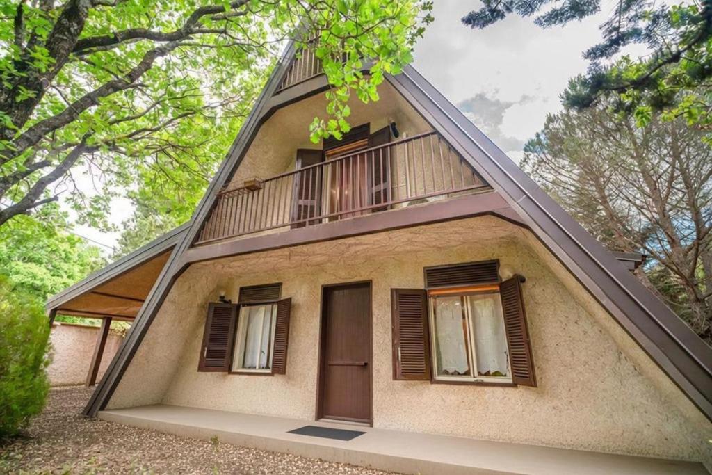a house with a porch and a balcony at Chalet Etna dreamers in Nicolosi