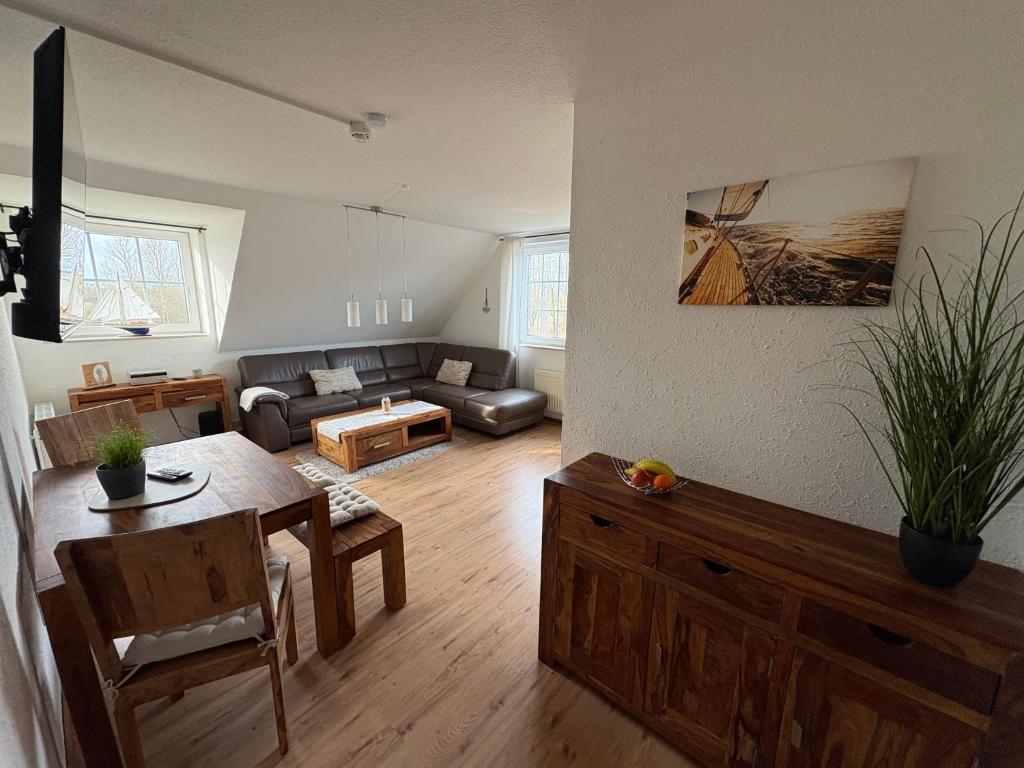 a living room with a couch and a table at Ostseekoje Koje 4 in Süssau