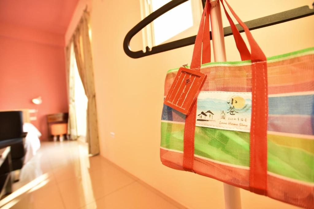 a tote bag hanging on a wall in a room at Lane Homestay in Dayin
