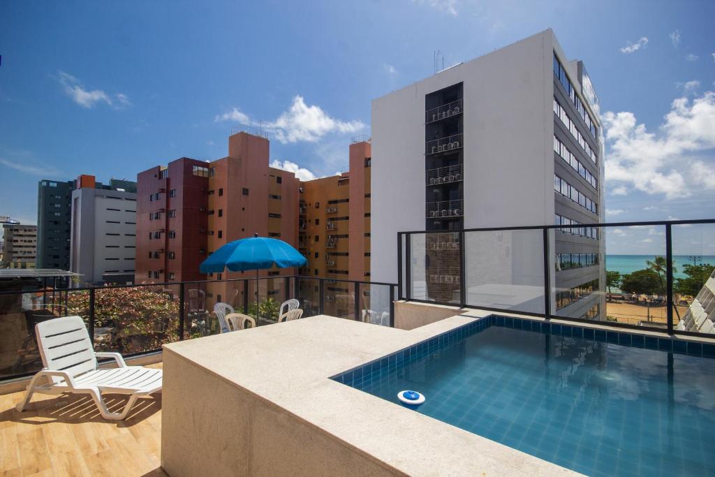 a balcony with a swimming pool on top of a building at Hotel Kazullo in Maceió