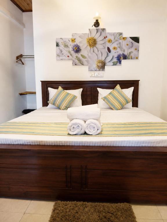 a bed with two towels on top of it at Ceylon Beach haven Uppuveli in Trincomalee