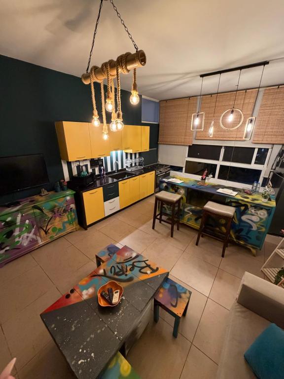 a living room with a table and a kitchen at Byout Beirut G3 in Beirut