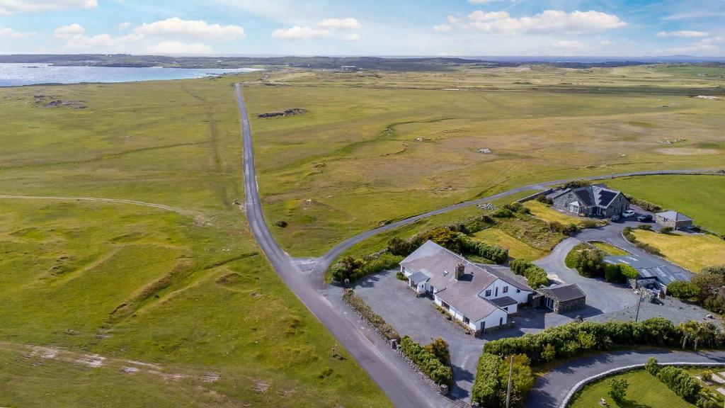 an aerial view of a house and a road at Conamara House in Ballyconneely