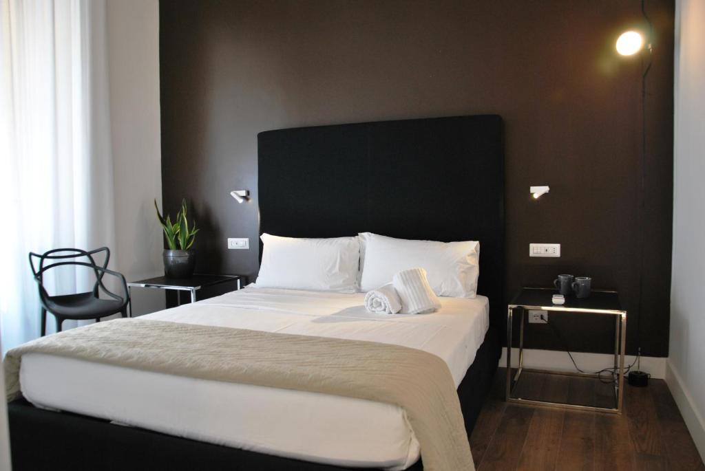 een slaapkamer met een groot bed met een zwart hoofdeinde bij App Leoncino Design Apartment in Rome in Rome