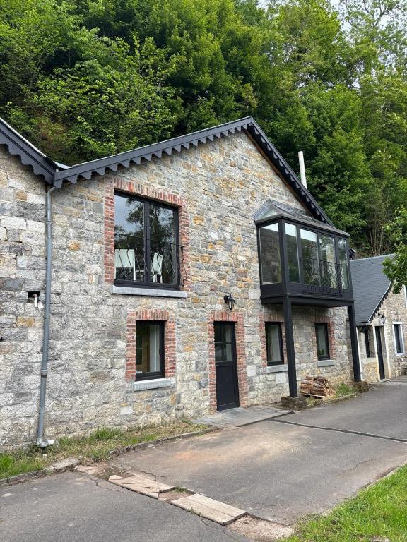 a stone house with a window on the side of it at Maison Camille in Hotton