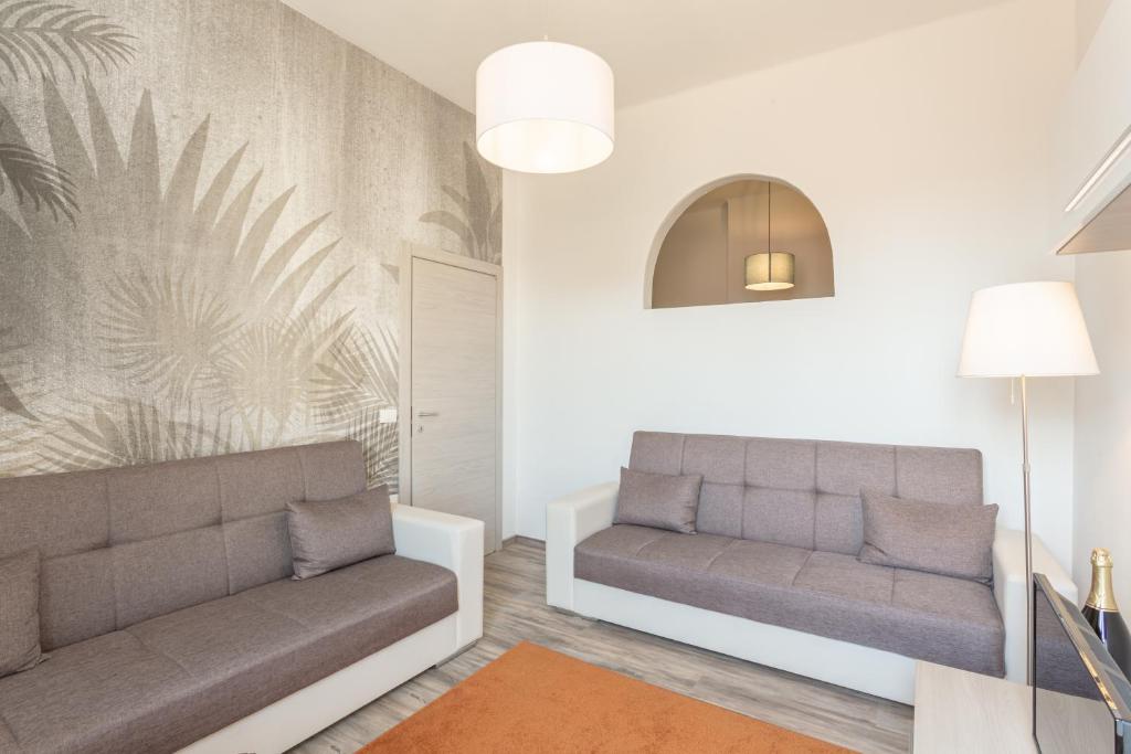 a living room with two couches and a couch at Verdi 185 by Pleiades Home in Livorno