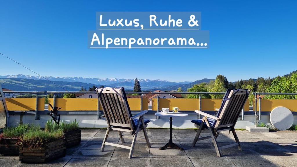 a patio with two chairs and a table on a balcony at Ihre exklusive Auszeit im Allgäu in Scheidegg