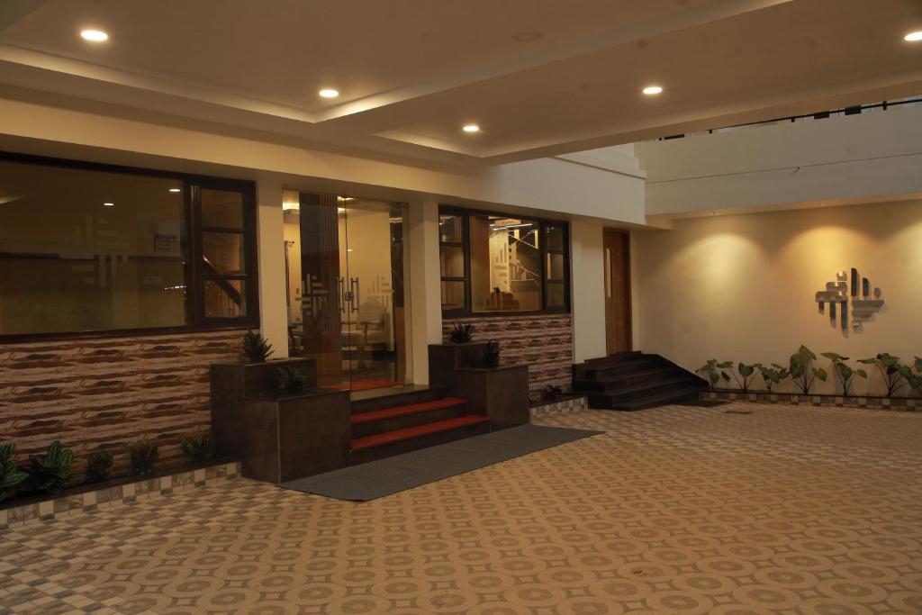 a lobby with a staircase in a building at Fathima Residency in Pattanapuram