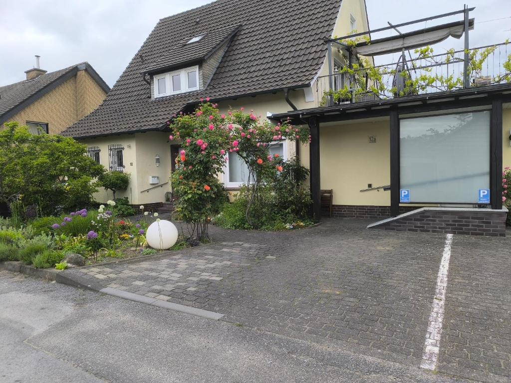 a house with a lot of flowers in front of it at Willy und Gudrun in Rheda-Wiedenbrück
