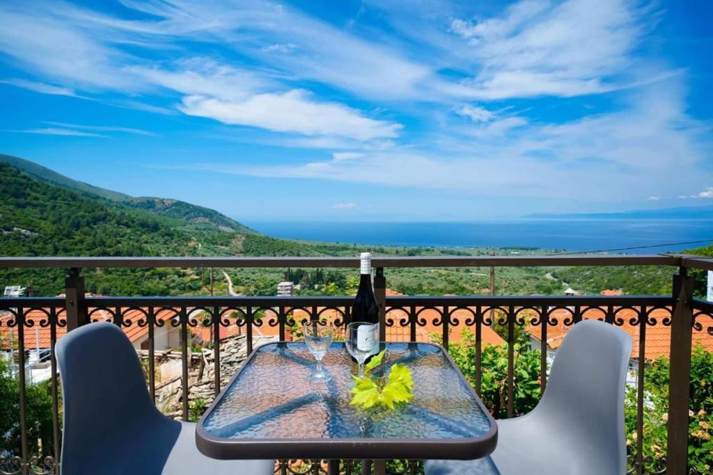 a bottle of wine sitting on a table on a balcony at Apanemia in Kallirákhi