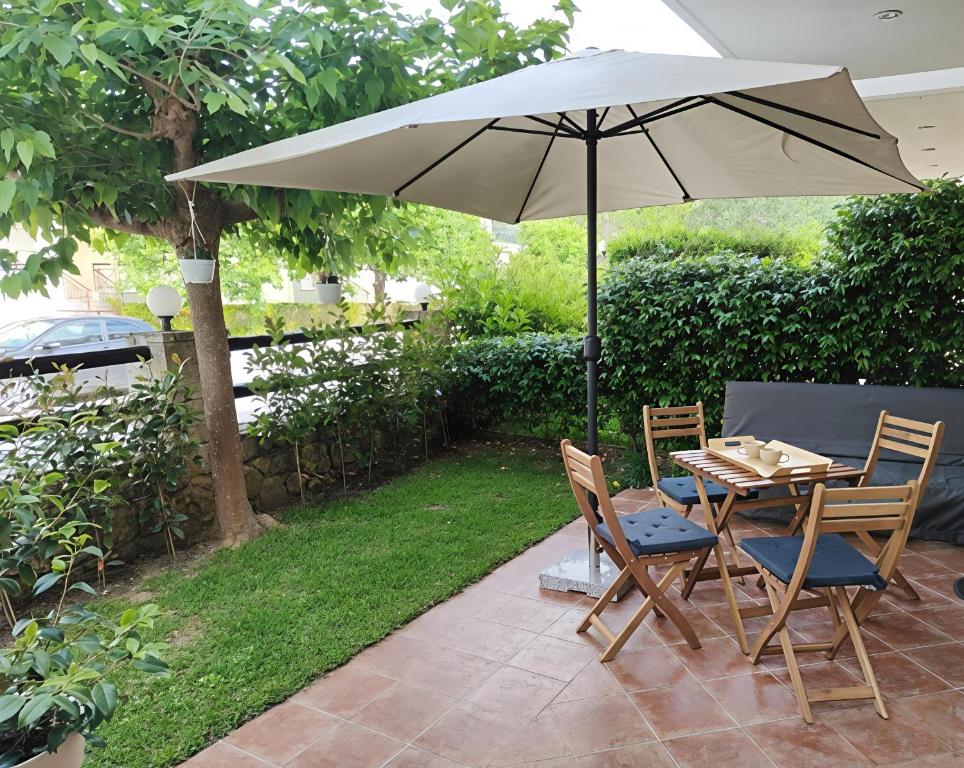 a table and two chairs with an umbrella at SiviriLovelyApartment in Siviri