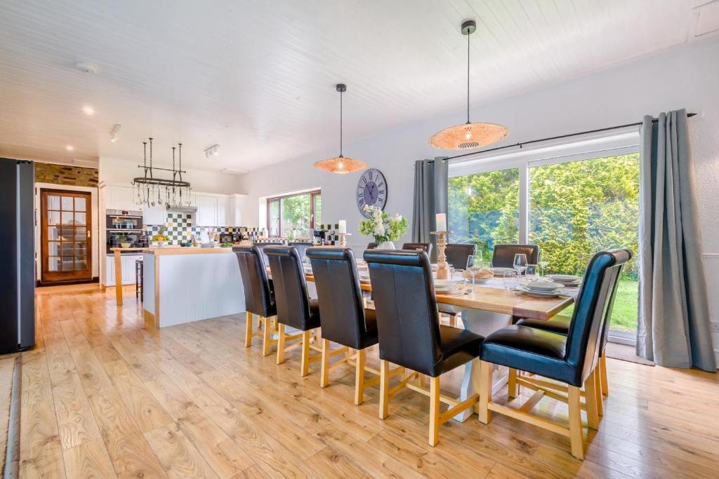 a dining room and kitchen with a table and chairs at 6 Bed in Hersham oc-t29211 in Stratton