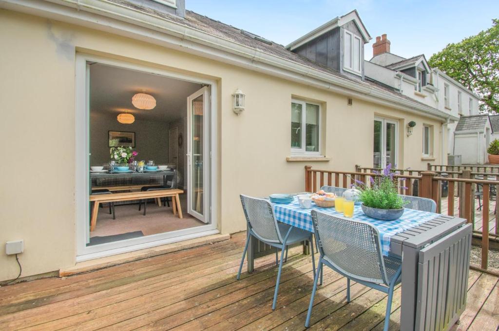 a patio with a table and chairs on a deck at 3 Bed in Tenby oc-93359 in Redberth