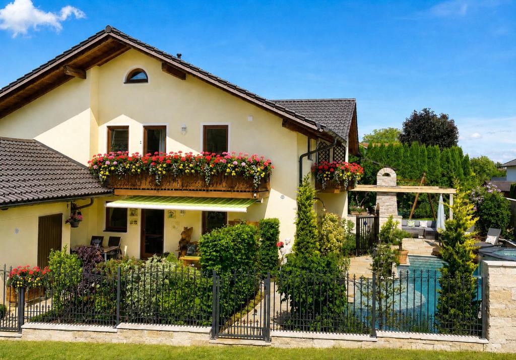 a house with flower boxes on the front of it at AlpenAppartement Traumzeit in Bernau am Chiemsee