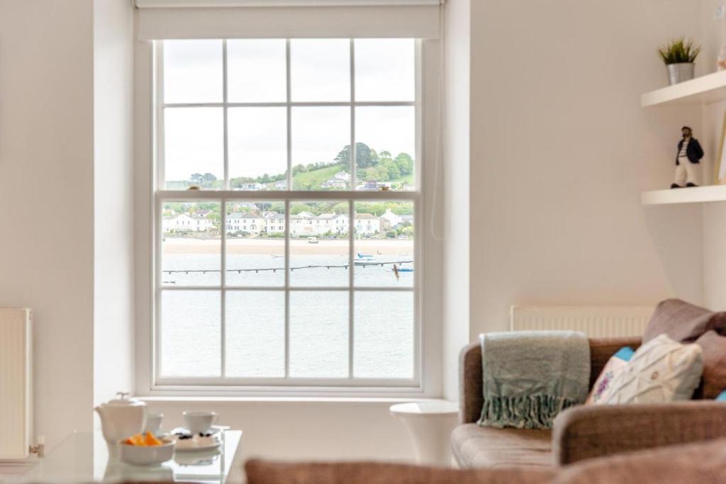 a living room with a large window with a view of the beach at 2 Bed in Appledore oc-loblof in Appledore