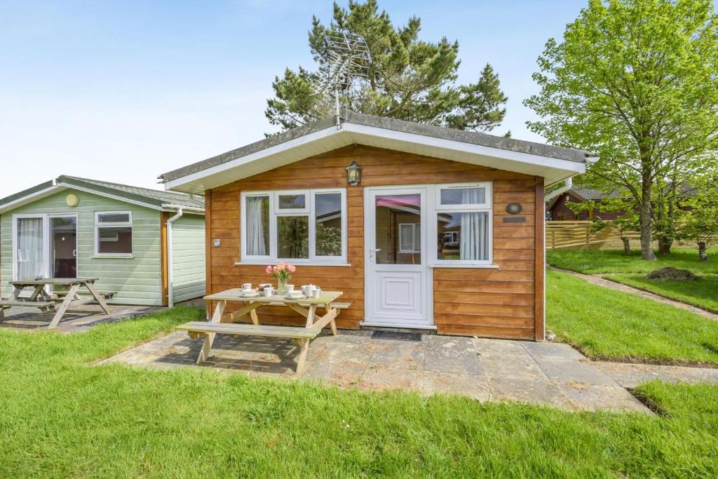 a tiny house with a picnic table in the yard at 2 Bed in St. Merryn oc-p00883 in Saint Merryn