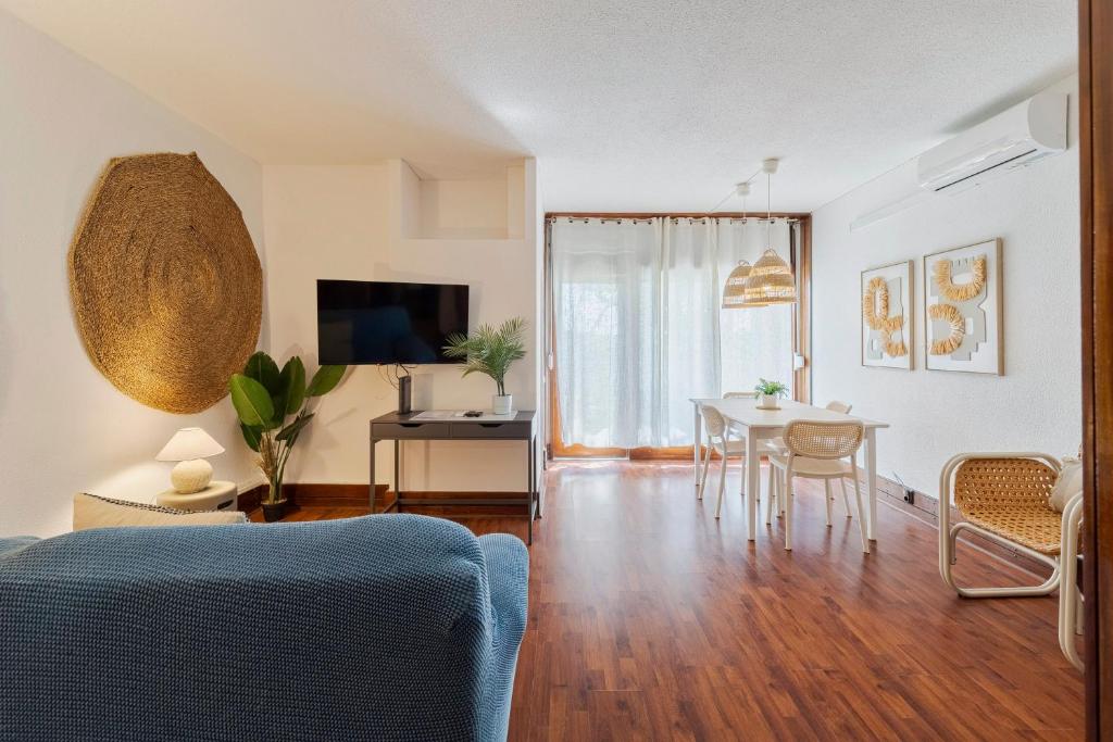 a living room with a table and a dining room at Serenity Troia, By Home Match in Troia