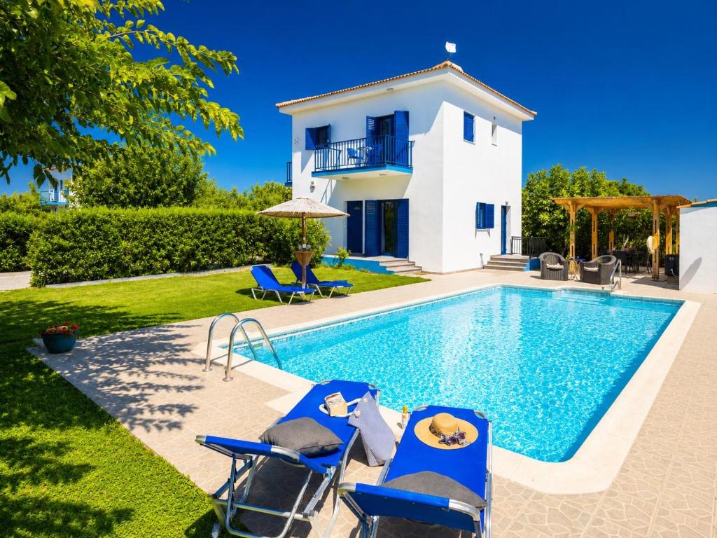 a villa with a swimming pool and a house at Villa Rotiana in Polis Chrysochous
