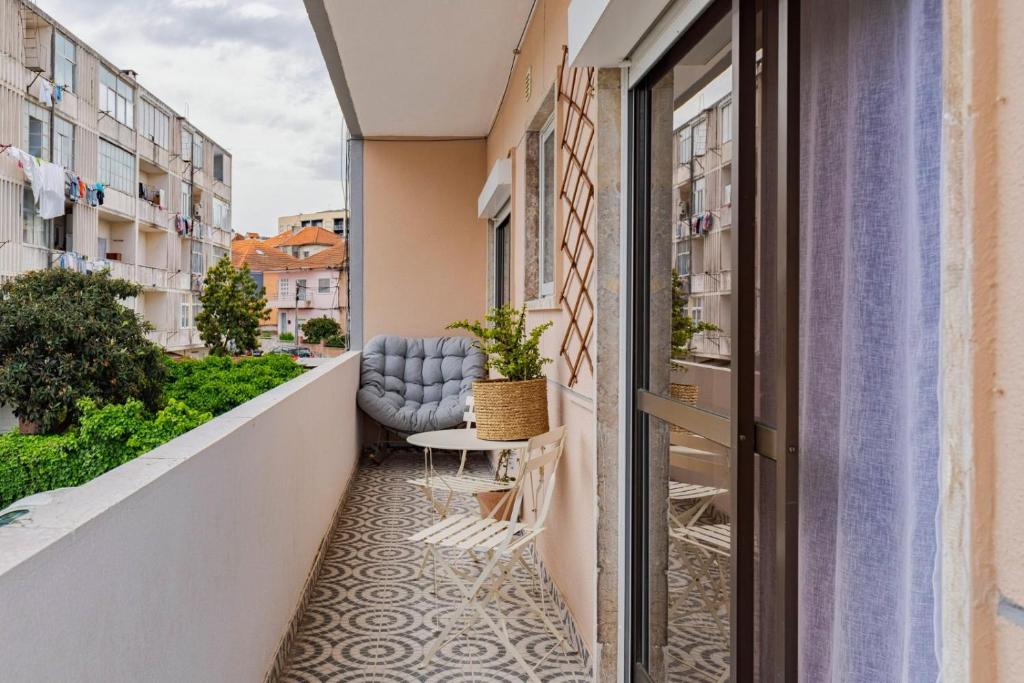 a balcony with a chair and a table at Casa Solace in Almada