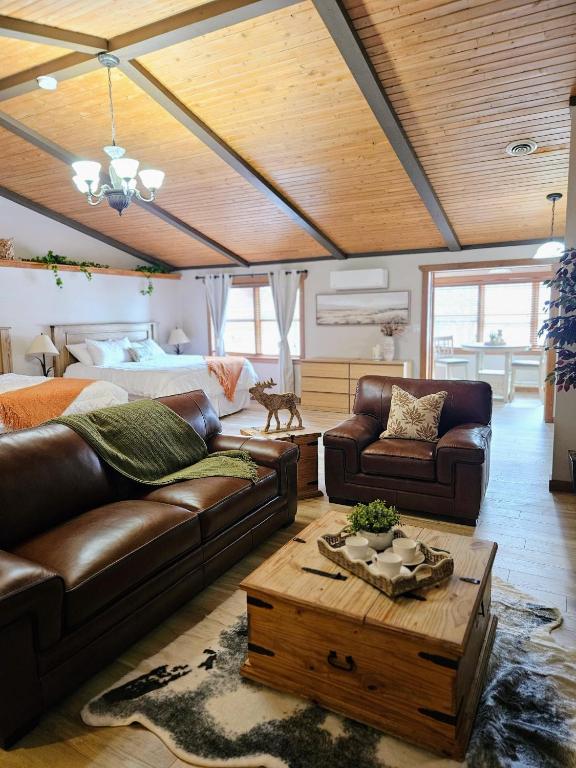 a living room with a couch and a table at For-Rest Inn and Spa in Bathurst