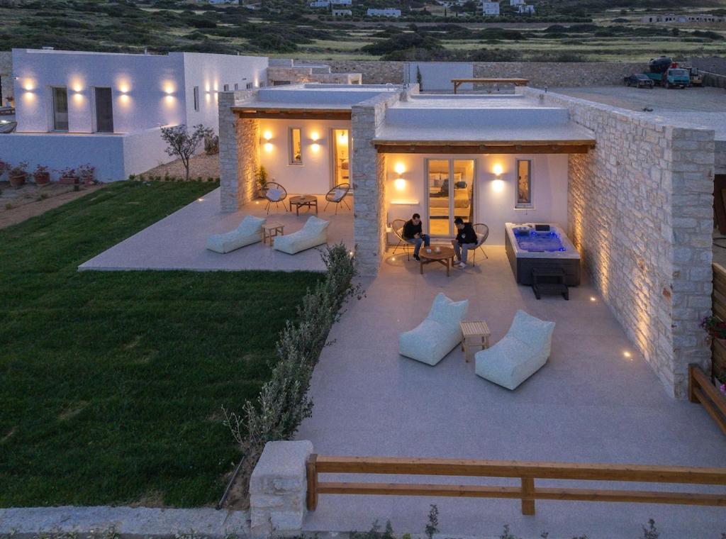 a patio with couches and tables on a house at Sunshine Medousa Suite in Glifades