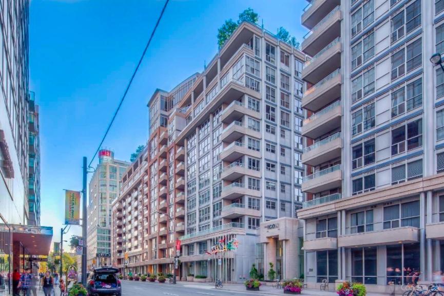 a tall building on a street in a city at Downtown Toronto Condo in Toronto