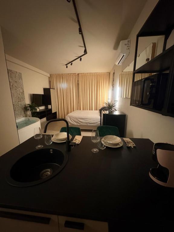 a bathroom with a sink and a room with a bed at Marilux oasi di relax in Marina di Carrara