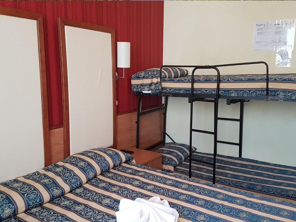Postel nebo postele na pokoji v ubytování Hotel Promenade Universale