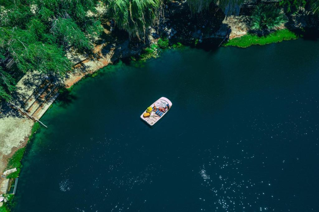 an aerial view of a boat in the water at The Bubbling Wells Oasis, 3 Homes on 107 Acres in Desert Hot Springs