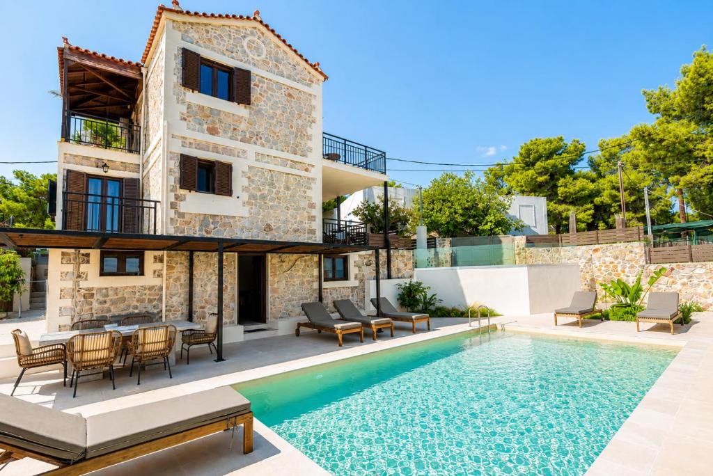 a villa with a swimming pool and a house at Villa Metochi in Skala