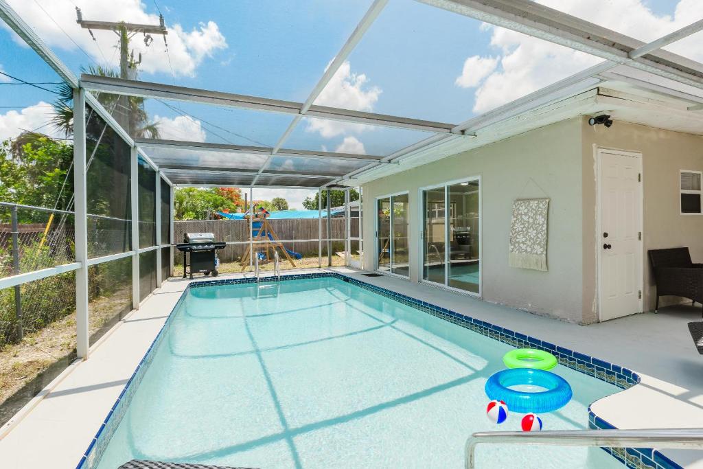 a swimming pool in a house with a glass ceiling at Florida Paradyse 10MIN DOWNTOWN Y 10 MIN BEACH in Fort Myers