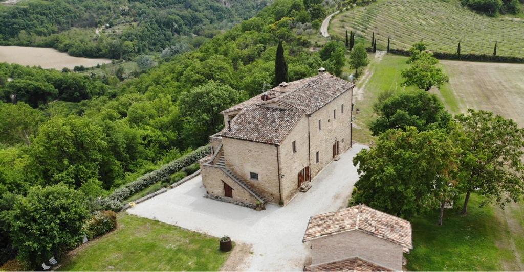 an aerial view of an old building in a field at Torre della Soara - Medieval Tower in the Umbrian Countryside in Città di Castello