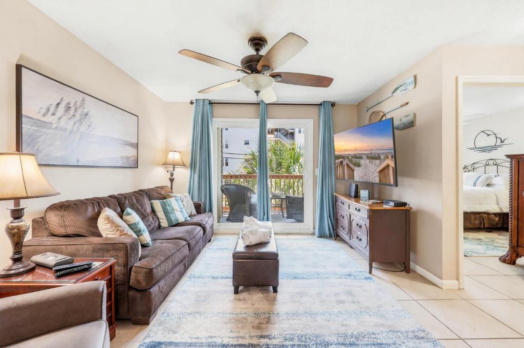 a living room with a couch and a ceiling fan at Cherry Grove Condo Steps to Beach Sleeps 8 in Myrtle Beach