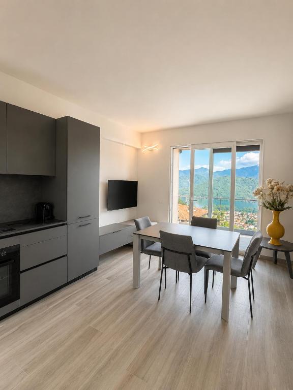 a kitchen and dining room with a table and chairs at Lake View Apartament 1 - Free Parking & Terrace in Cadegliano Viconago