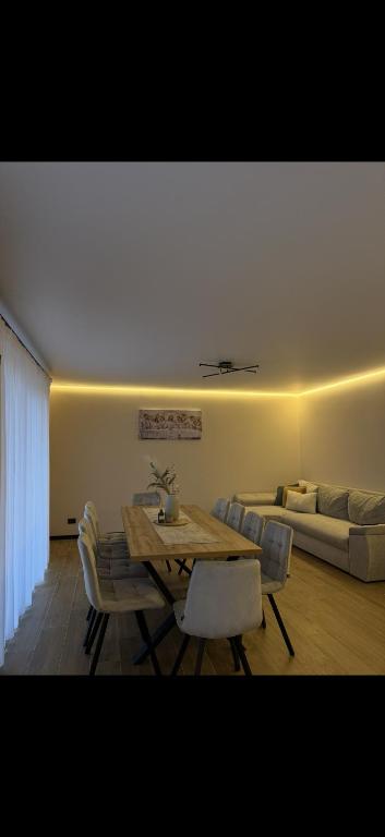 a living room with a table and a couch at House on The Hill Bukovel in Palyanytsya