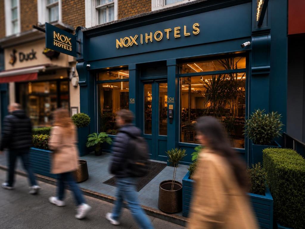 people walking down a street in front of a store at NOX Hyde Park in London