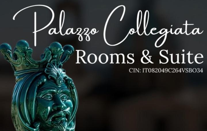 a green vase with a head on top of it at Palazzo Collegiata Rooms & Suite in Monreale