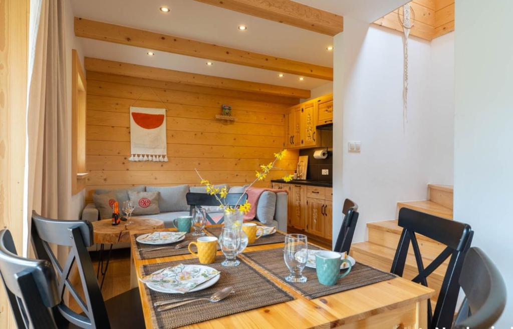 a dining room with a wooden table and chairs at Heidi in Zakopane