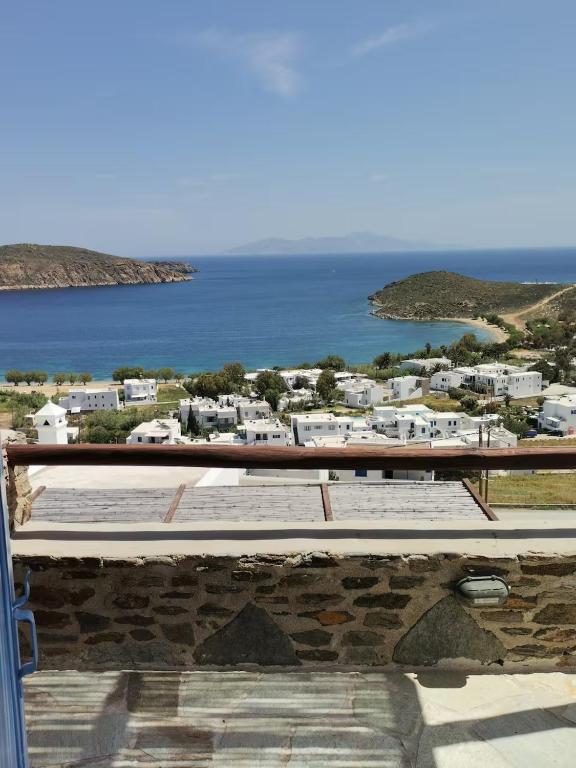 a balcony with a view of the ocean and buildings at Flora's House in Livadakia