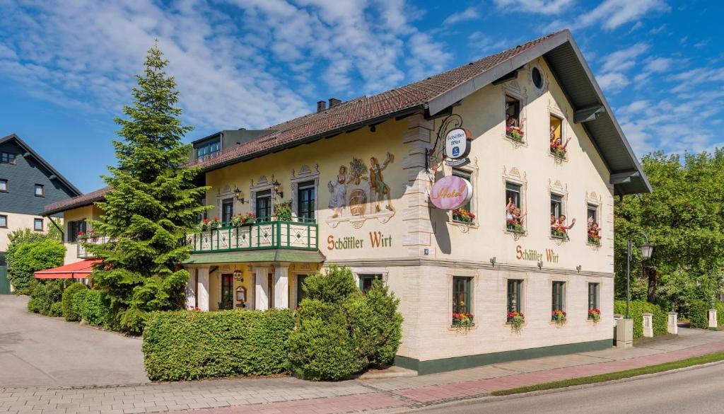 a large white building with a sign on it at Hotel Schäfflerwirt in Aschheim