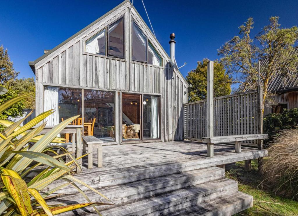 a wooden house with a porch and a deck at Adventure Base in Ohakune