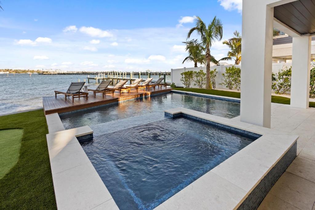 an infinity pool in a house with a view of the water at Big Nauti in Bradenton Beach