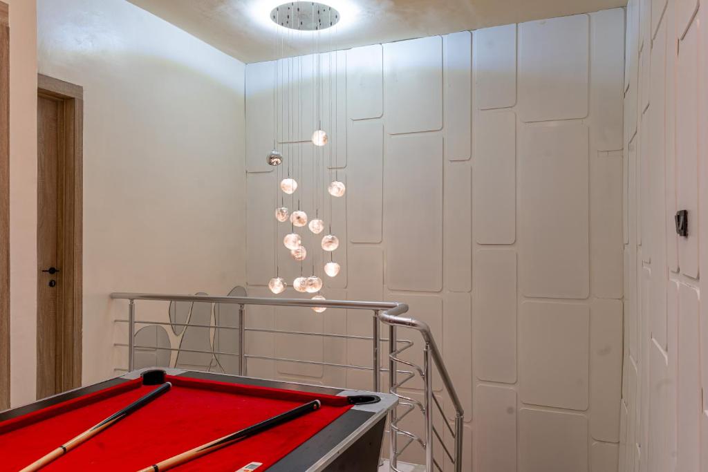 a ping pong table in a room with white walls at Luxe Haven in Lekki