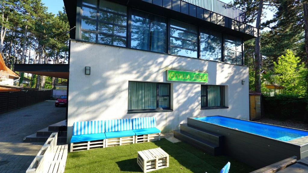 a building with a swimming pool in front of it at VilLa AdeLe in Siófok