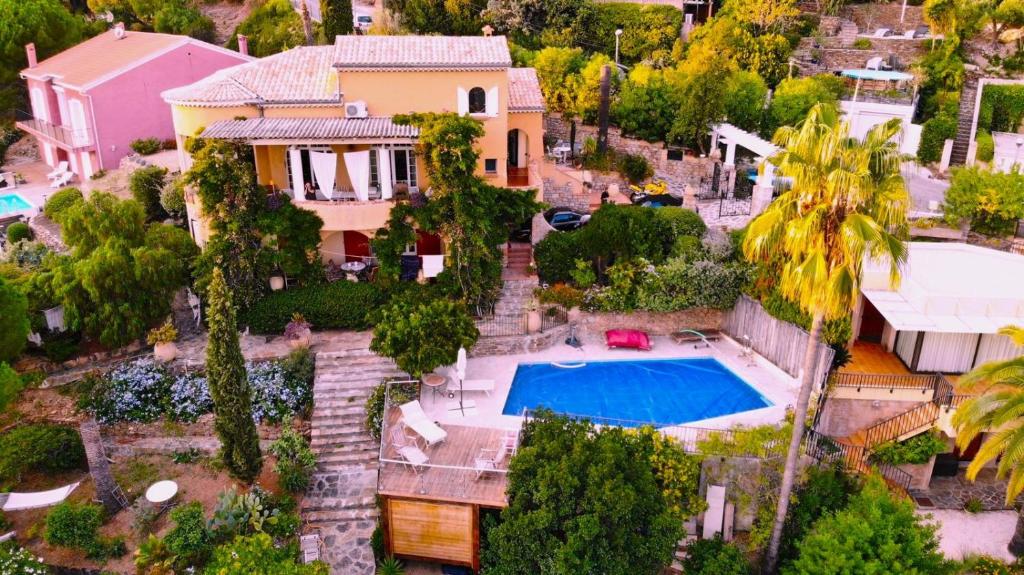 an aerial view of a house with a swimming pool at Villa Les Dauphins in Le Lavandou