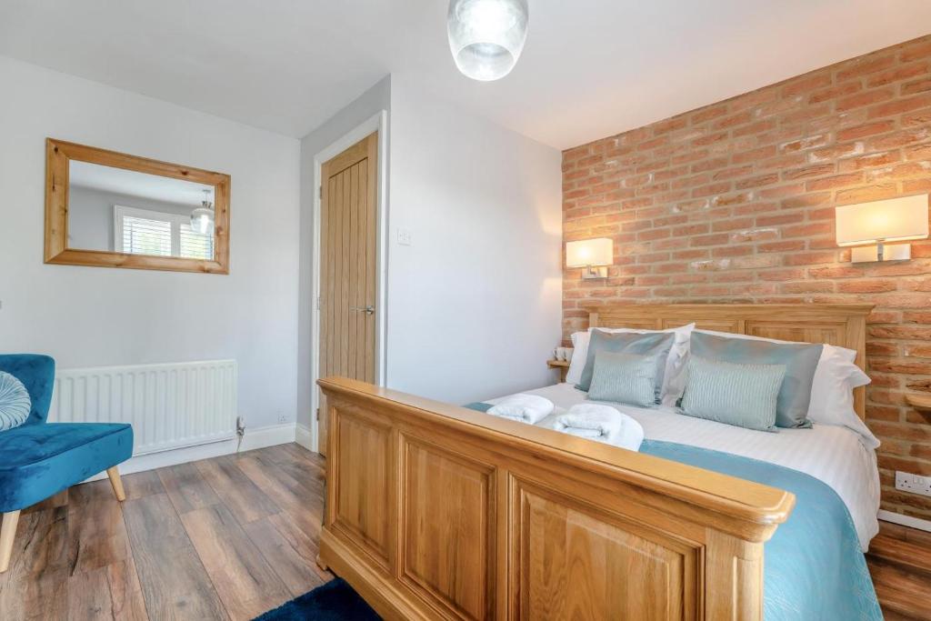 a bedroom with a bed and a brick wall at 1 Bed in Middlesbrough oc-79273 in Great Ayton