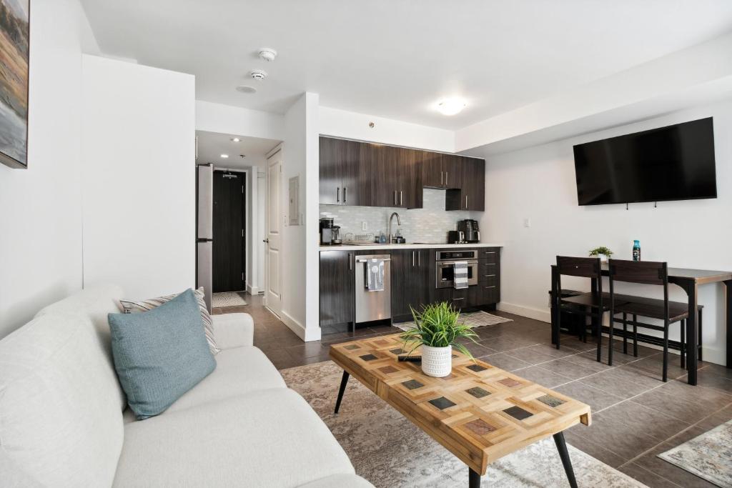 a living room with a couch and a table at Great Located Studio perfect for 2 with parking in Toronto