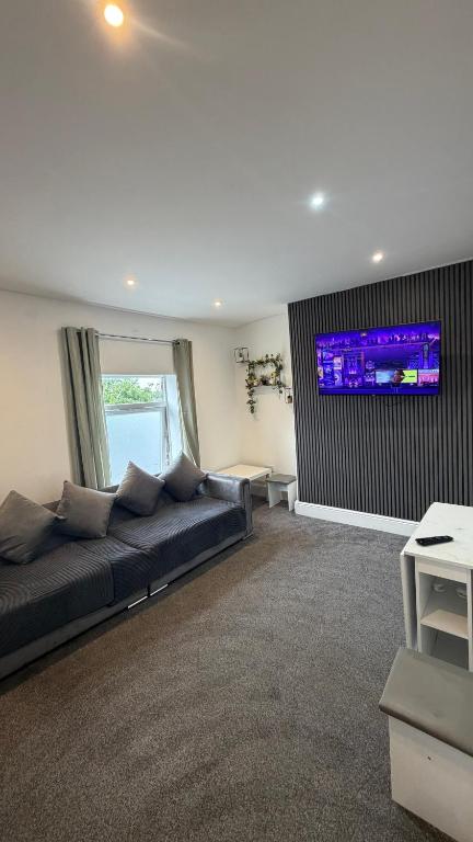 a living room with a couch and a large window at Beach & city Homestay in Waterloo