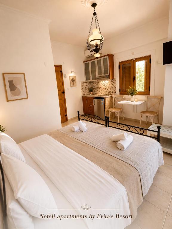 a bedroom with a large bed and a bathroom at NEFELI by Evita's Resort in Poros
